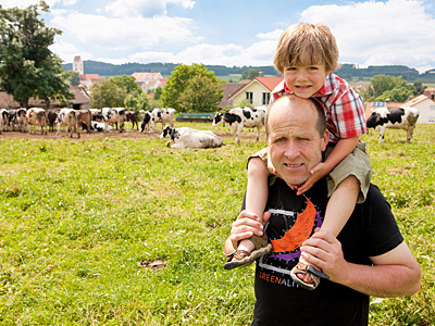 © Feneberg/Bio mit Gesicht Betriebsleiter mit Kind vor Rinderweide
